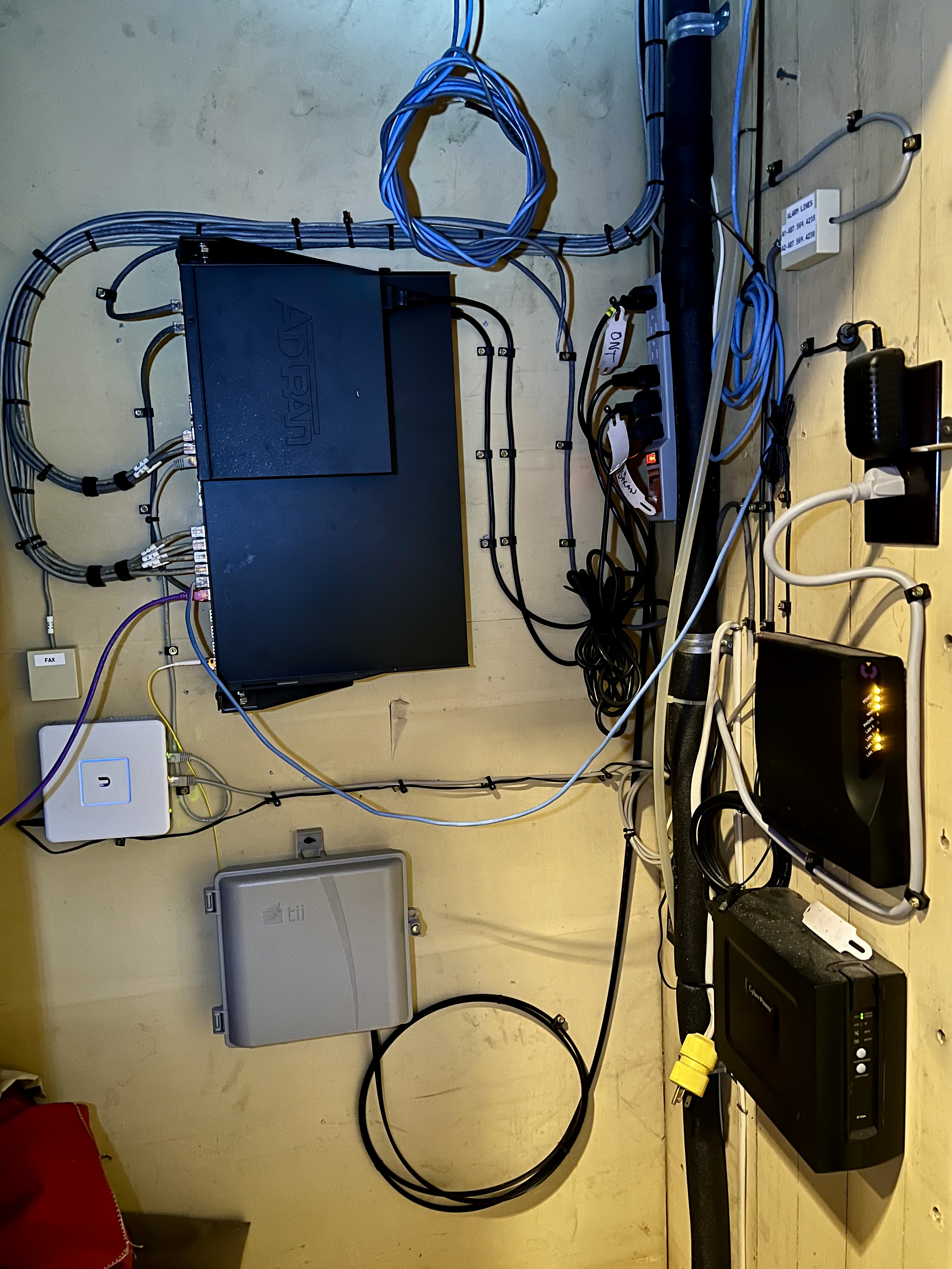 Messy, disorganized network closet before professional installation